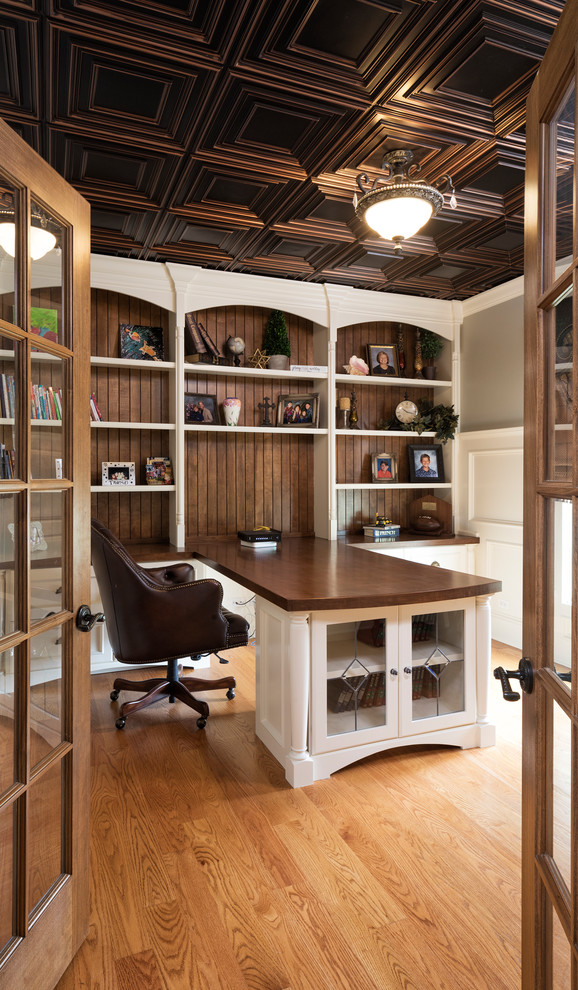 Mid-sized traditional home office in Chicago with grey walls, medium hardwood floors, a built-in desk and brown floor.