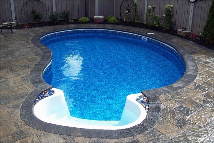 Pool - mid-sized transitional backyard custom-shaped and concrete paver lap pool idea in Toronto