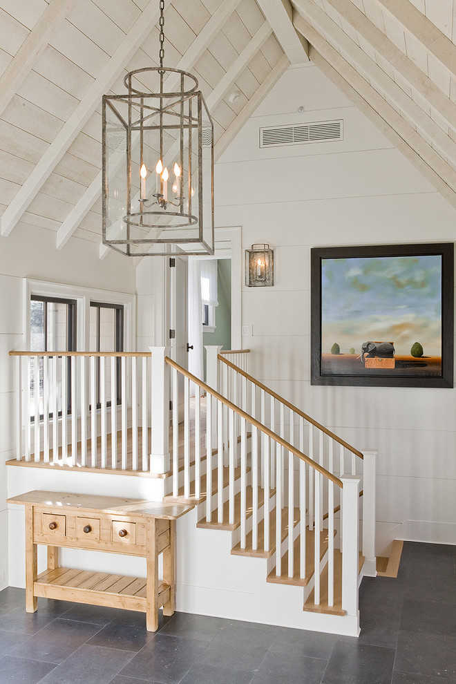 This is an example of a transitional foyer in Boston with white walls.