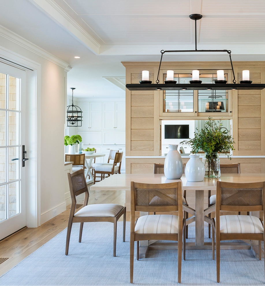 Photo of a beach style dining room in Providence with white walls, medium hardwood floors, brown floor, timber, recessed and wood walls.