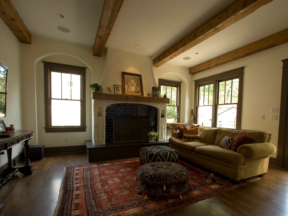 This is an example of a mediterranean living room in Nashville with dark hardwood floors and a standard fireplace.