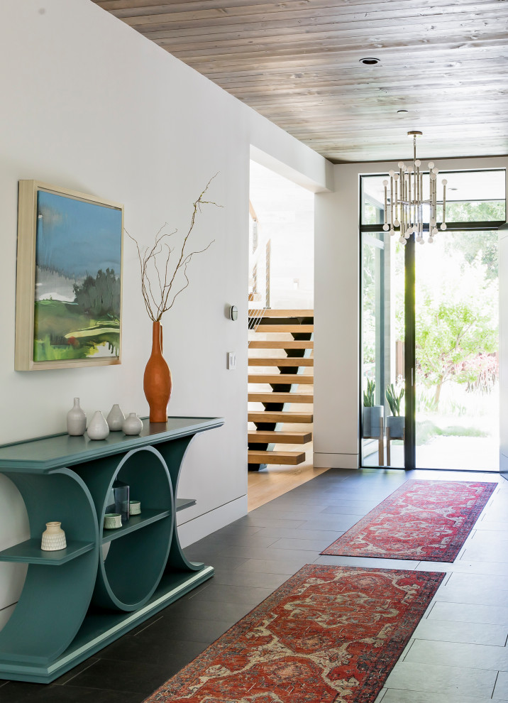 This is an example of a contemporary entry hall in San Francisco with white walls, wood and slate floors.