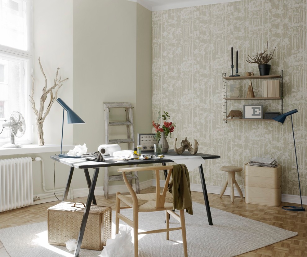 Inspiration for a scandinavian study room in Saint Petersburg with beige walls, light hardwood floors, a freestanding desk and beige floor.