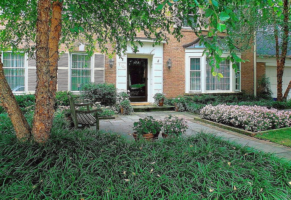 This is an example of a mid-sized transitional courtyard full sun garden for summer in DC Metro with a garden path and natural stone pavers.