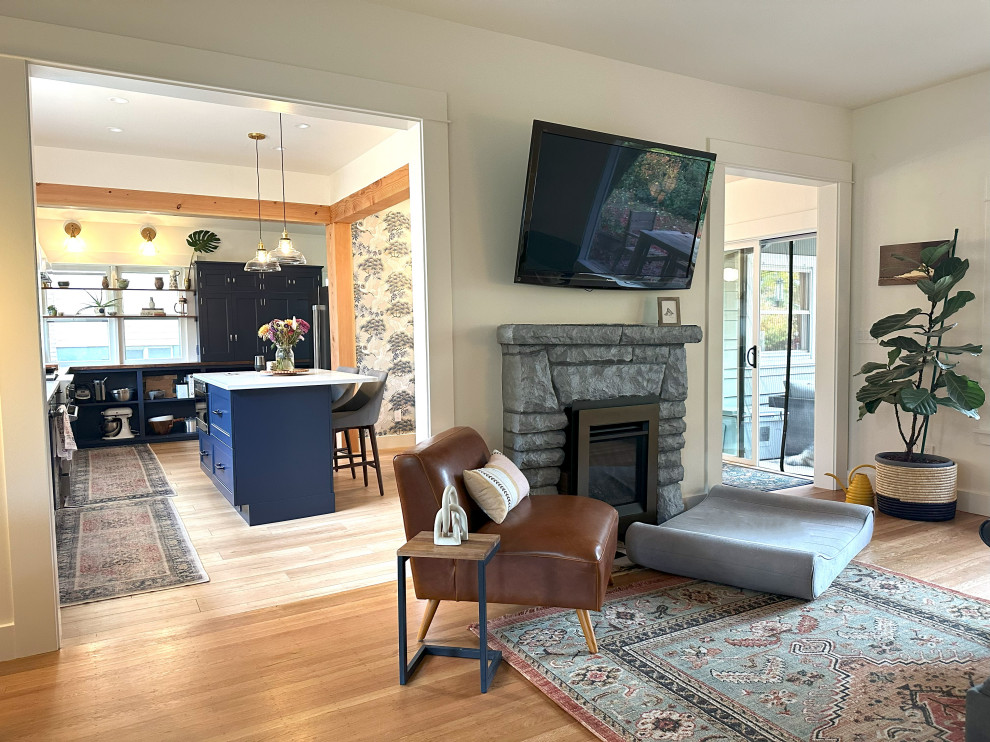 Mid-sized transitional open concept living room in Portland with white walls, medium hardwood floors, a standard fireplace, a concrete fireplace surround, a wall-mounted tv and beige floor.