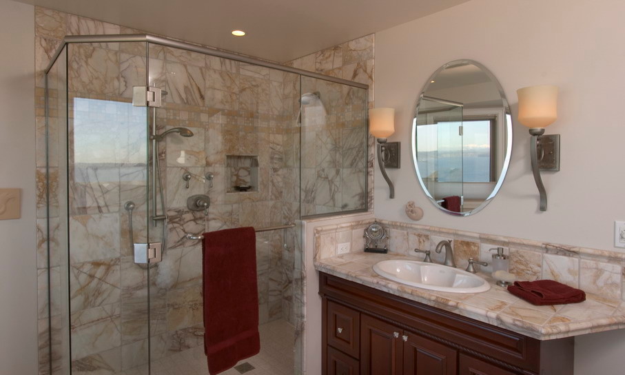 This is an example of a contemporary bathroom in Seattle with a vessel sink, furniture-like cabinets, granite benchtops and beige tile.