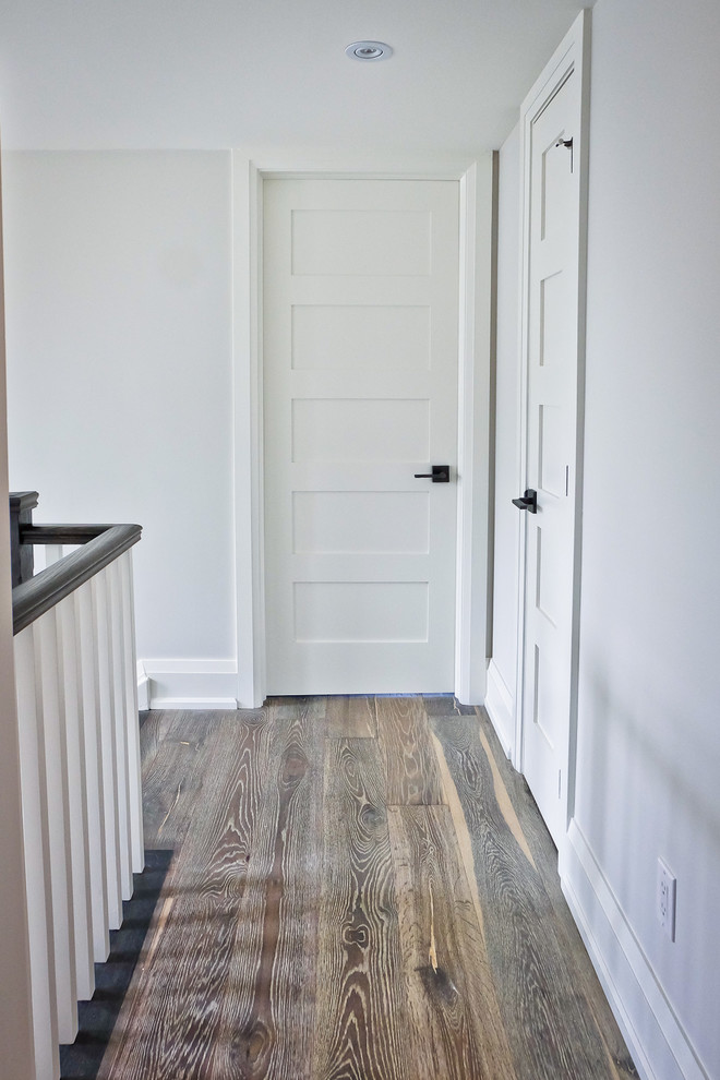 Mid-sized transitional hallway in Toronto with white walls and medium hardwood floors.