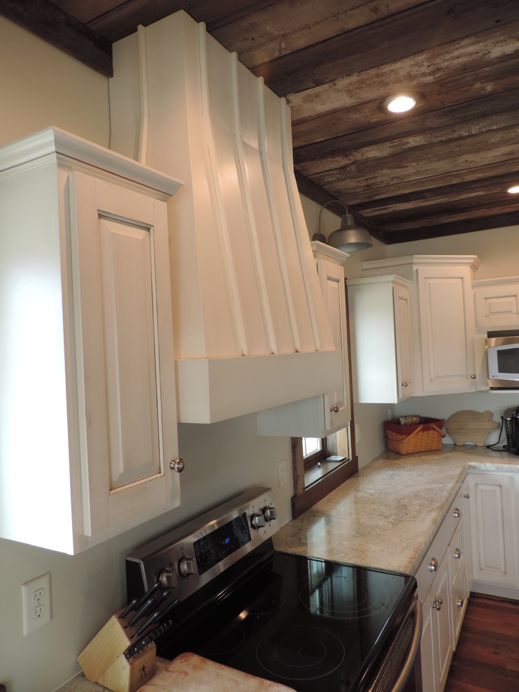 Eat-in kitchen - large rustic u-shaped dark wood floor eat-in kitchen idea with a farmhouse sink, raised-panel cabinets, white cabinets, marble countertops, stainless steel appliances and an island