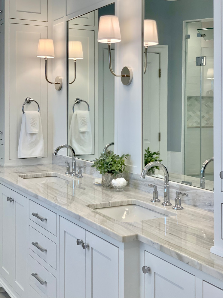 Design ideas for a classic ensuite bathroom in Bridgeport with shaker cabinets, white cabinets, a freestanding bath, a double shower, white tiles, porcelain tiles, blue walls, porcelain flooring, a submerged sink, marble worktops, grey floors, a hinged door, a wall niche, double sinks, a built in vanity unit and panelled walls.