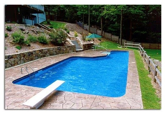 Inspiration for a backyard stone and custom-shaped pool remodel