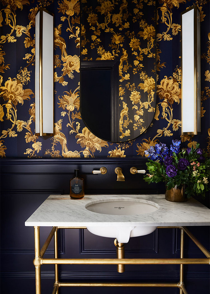 Inspiration for a transitional powder room in Melbourne with multi-coloured walls, a console sink and white benchtops.