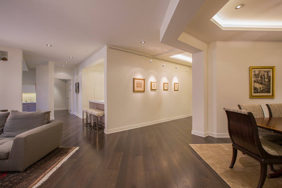Example of a mid-sized transitional medium tone wood floor hallway design in DC Metro with white walls
