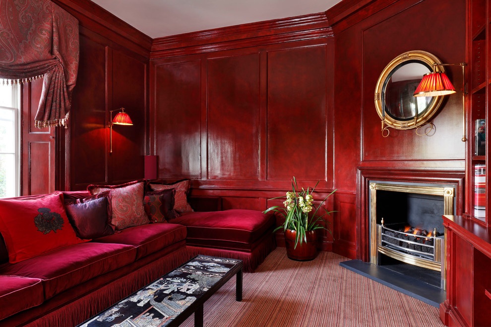 Mid-sized traditional enclosed family room in London with red walls, carpet, a corner fireplace, a metal fireplace surround and red floor.