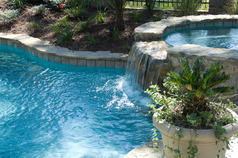 Inspiration for a large arts and crafts backyard custom-shaped natural pool in Other with a hot tub and natural stone pavers.