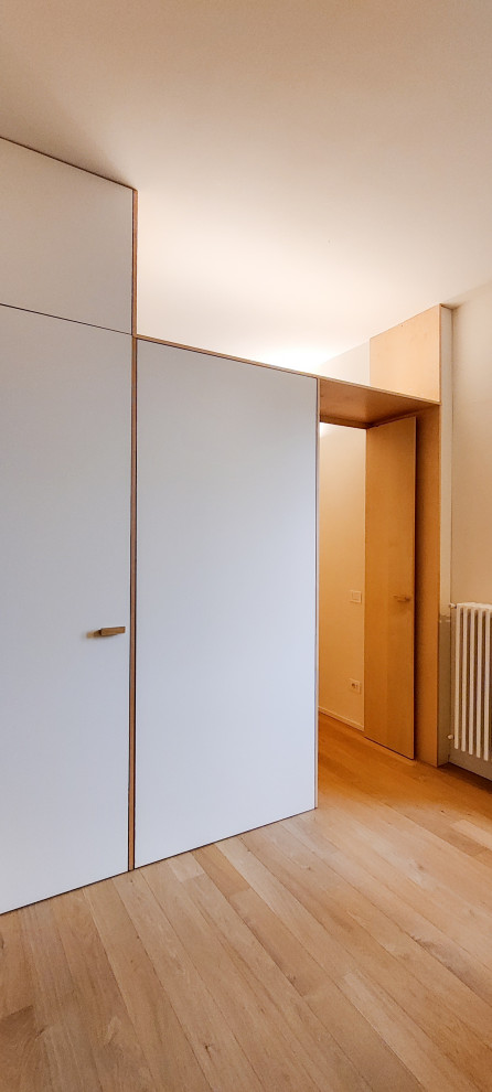 Example of a small trendy open concept light wood floor living room design in Milan with beige walls