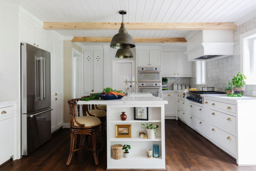 Dream farmhouse kitchen with white shaker kitchen cabinet units, a central island, and a stainless steel French door refrigerator
