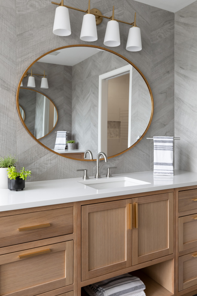 Bathroom - mid-sized transitional master gray tile and porcelain tile single-sink bathroom idea in Seattle with shaker cabinets, light wood cabinets, gray walls, an undermount sink, quartz countertops, white countertops and a built-in vanity