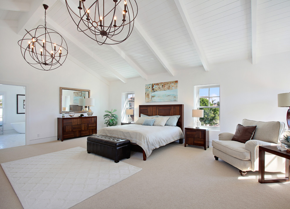 This is an example of a beach style bedroom in Orange County with white walls and carpet.