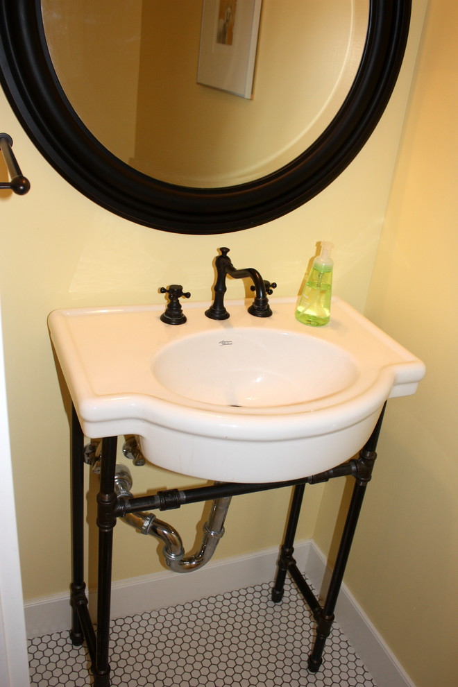 This is an example of a small arts and crafts 3/4 bathroom in Salt Lake City with open cabinets, a two-piece toilet, ceramic tile, yellow walls, ceramic floors and an integrated sink.