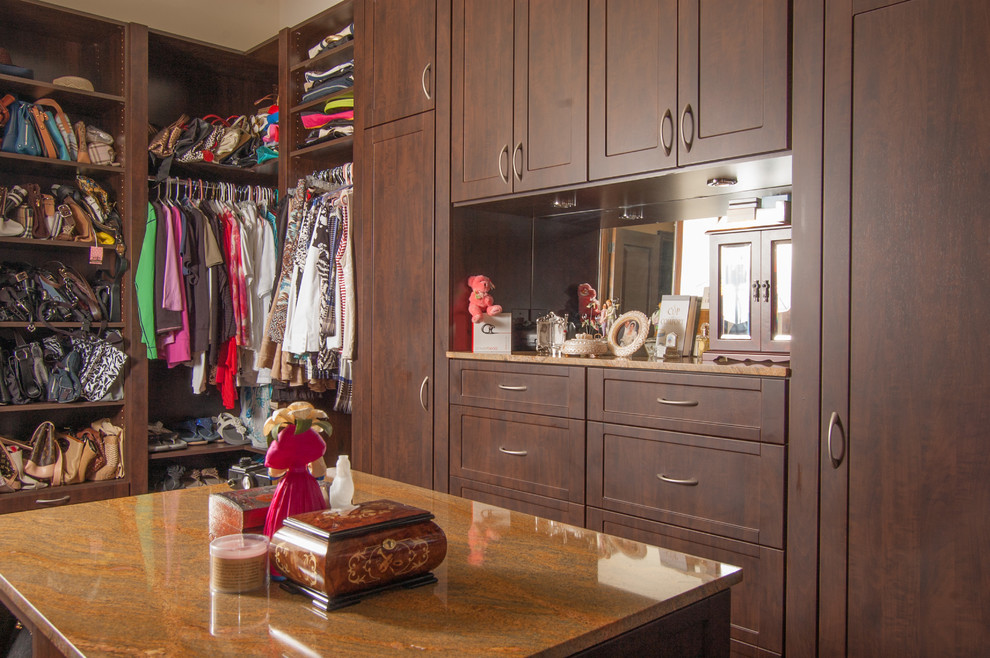Design ideas for a mid-sized traditional gender-neutral walk-in wardrobe in Miami with shaker cabinets, dark wood cabinets and porcelain floors.