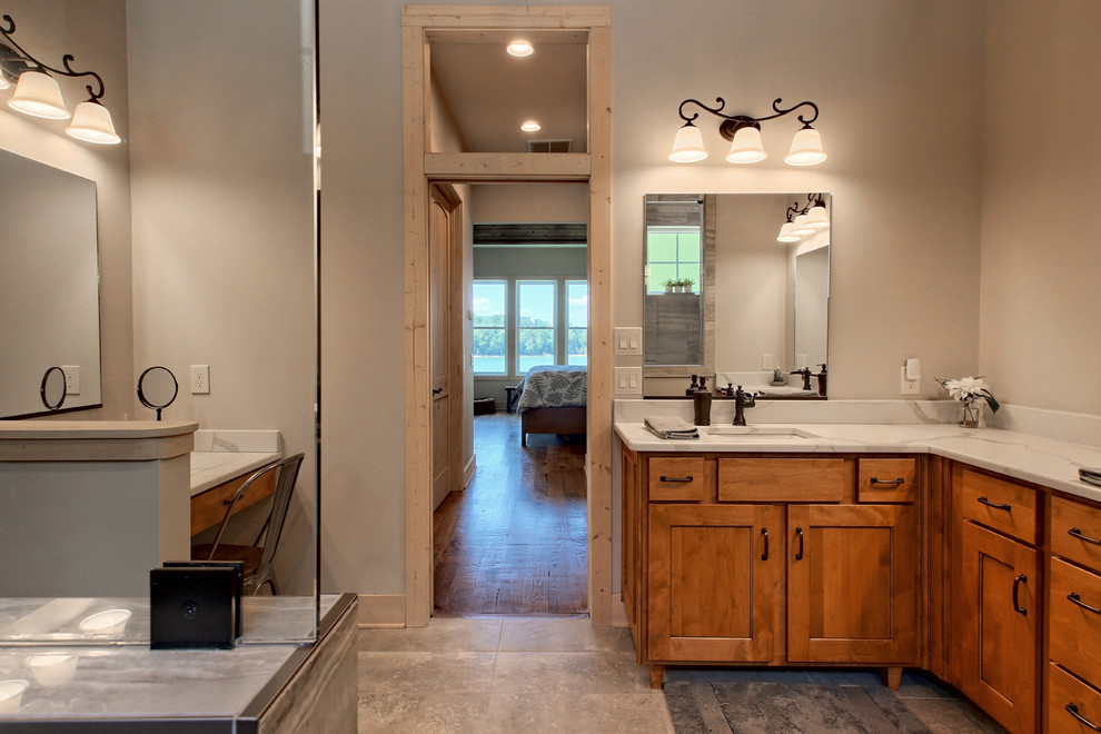 This is an example of a large arts and crafts bathroom in Atlanta with shaker cabinets, medium wood cabinets, an open shower, a two-piece toilet, multi-coloured tile, ceramic tile, beige walls, ceramic floors, an undermount sink, engineered quartz benchtops, grey floor, an open shower and white benchtops.