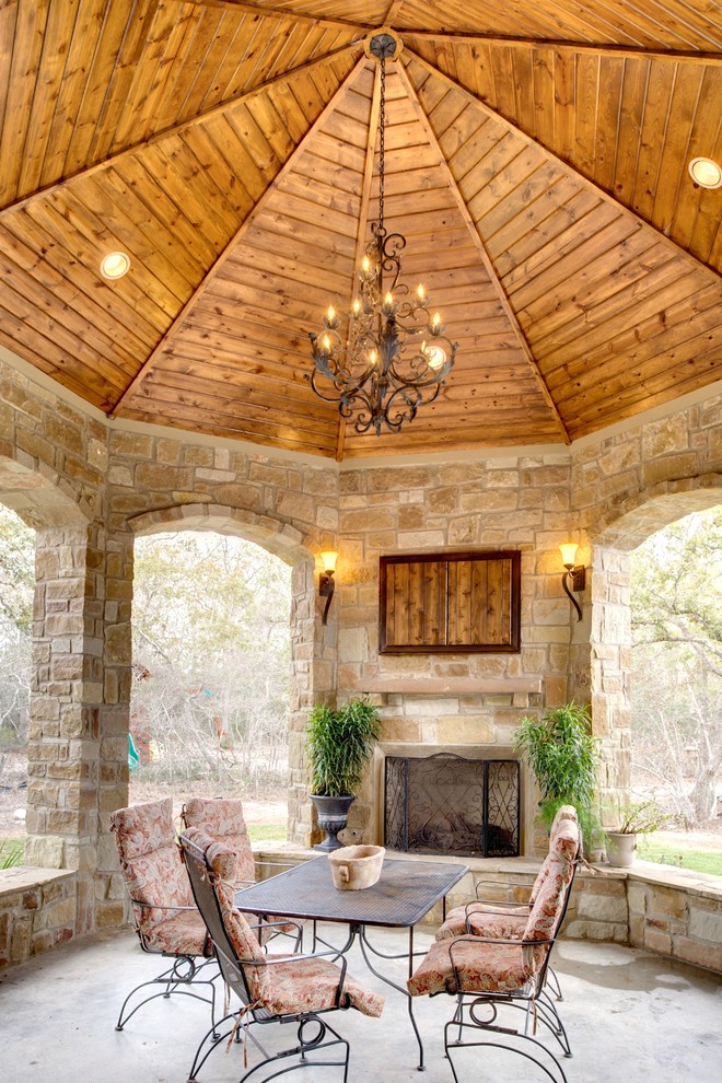 Inspiration for a mid-sized traditional backyard patio in Austin with a fire feature, concrete slab and a gazebo/cabana.