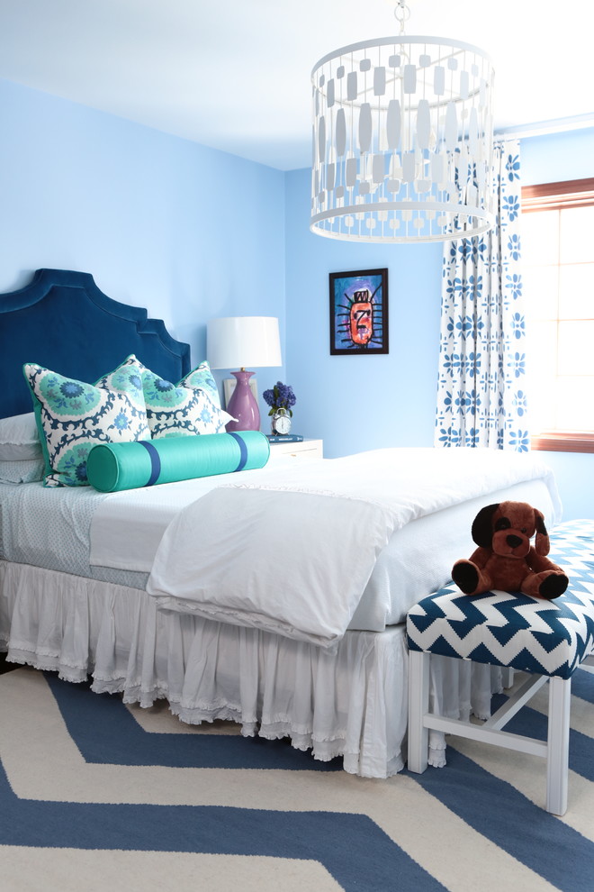 Photo of a transitional kids' bedroom for girls in Other with blue walls and multi-coloured floor.