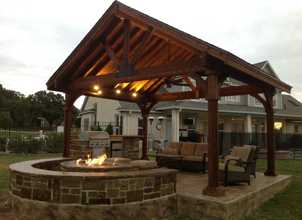 Design ideas for a mid-sized arts and crafts backyard patio in Dallas with an outdoor kitchen, stamped concrete and a gazebo/cabana.