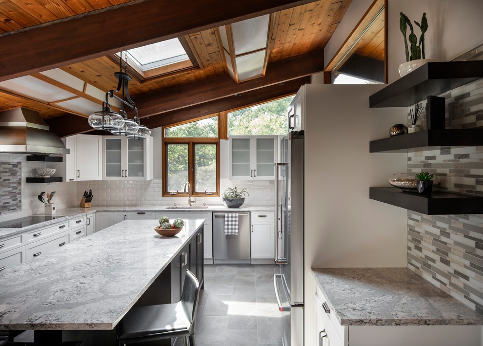 Mid-sized midcentury u-shaped eat-in kitchen in Boston with an undermount sink, flat-panel cabinets, white cabinets, quartz benchtops, multi-coloured splashback, subway tile splashback, stainless steel appliances, porcelain floors, with island, grey floor and white benchtop.