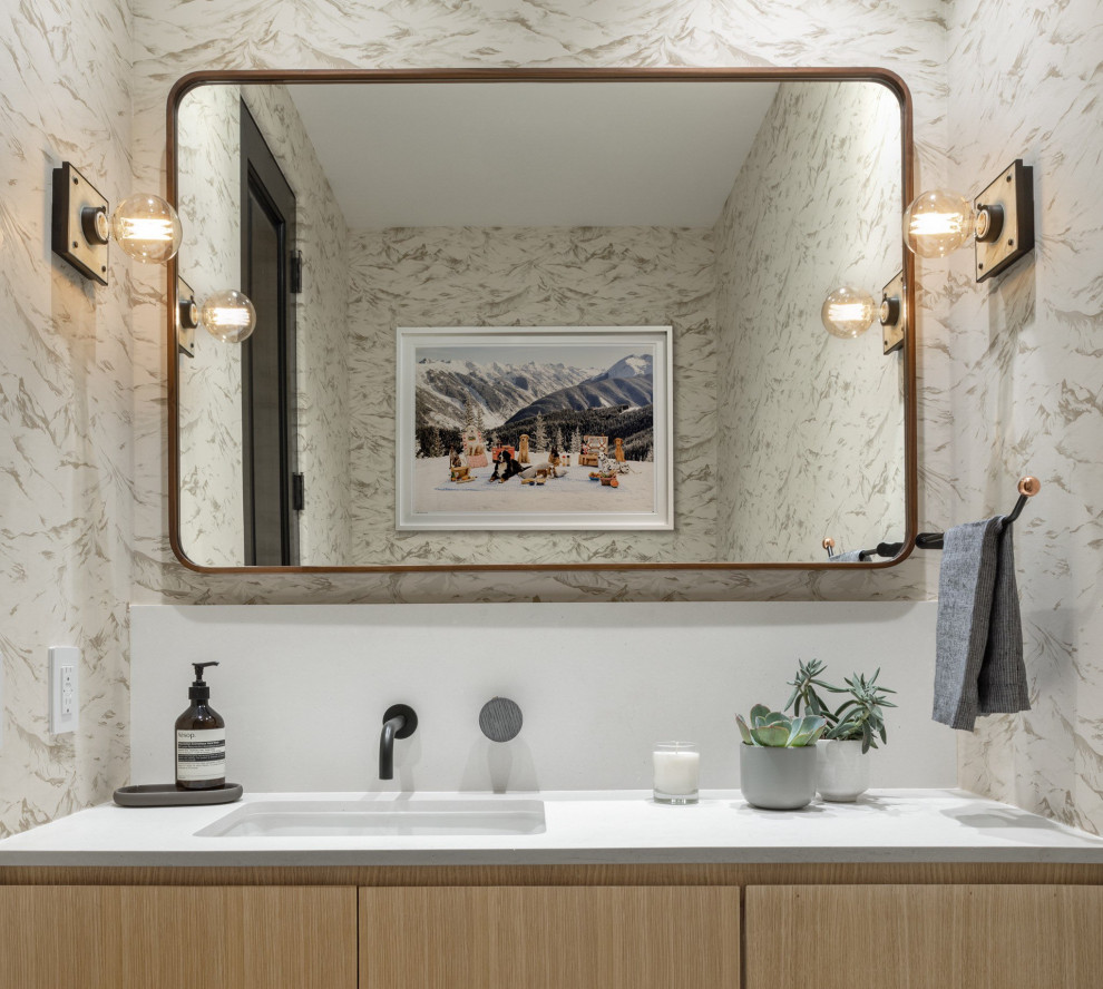 Powder room - mid-sized transitional beige tile and mosaic tile wallpaper powder room idea in Denver with flat-panel cabinets, medium tone wood cabinets, multicolored walls, a drop-in sink, quartz countertops, white countertops and a built-in vanity