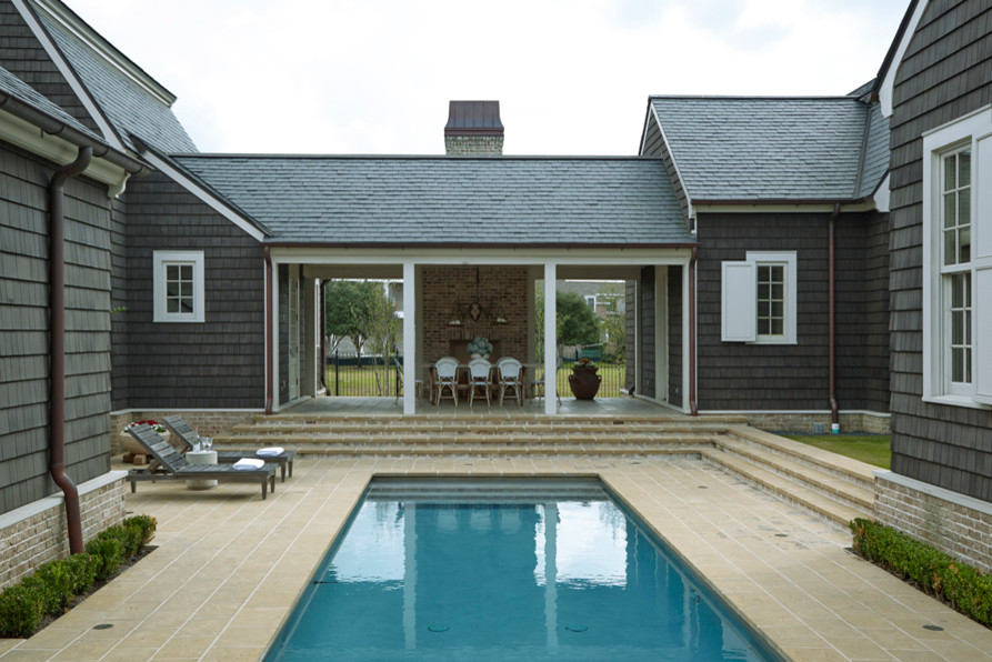 Inspiration for a large coastal backyard stone and rectangular pool remodel in Houston