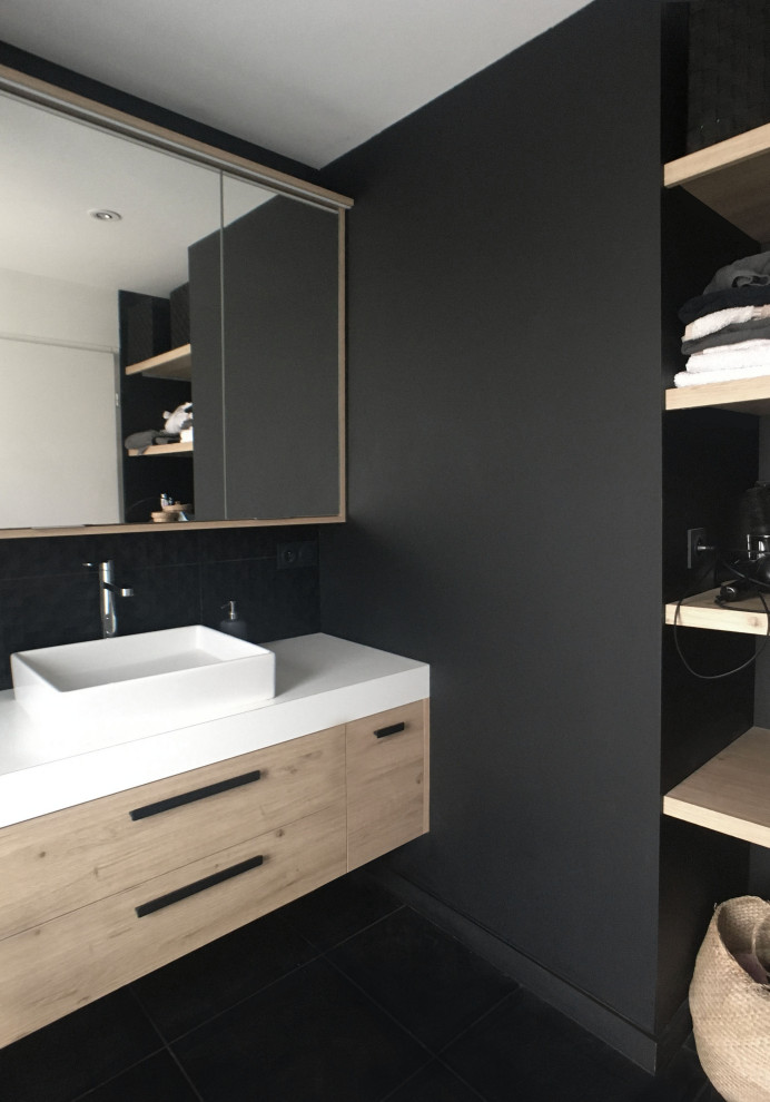 Photo of a small contemporary 3/4 bathroom in Other with light wood cabinets, a curbless shower, black tile, slate floors, a drop-in sink, laminate benchtops, black floor, an open shower, white benchtops, a single vanity and a floating vanity.