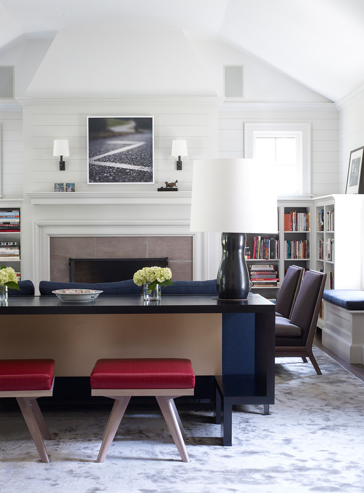 Photo of a mid-sized modern enclosed living room in Bridgeport with a library, white walls, dark hardwood floors, a standard fireplace, a tile fireplace surround, no tv and brown floor.