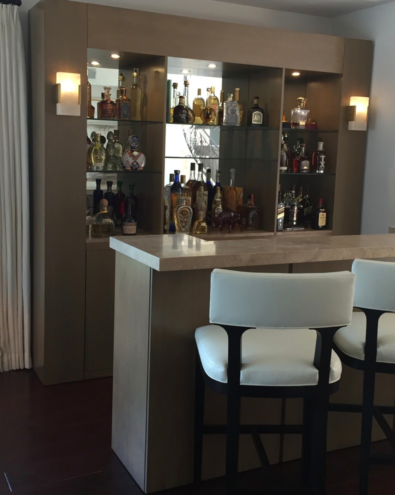Photo of a large contemporary galley seated home bar in Los Angeles with flat-panel cabinets, light wood cabinets, marble benchtops, mirror splashback and dark hardwood floors.