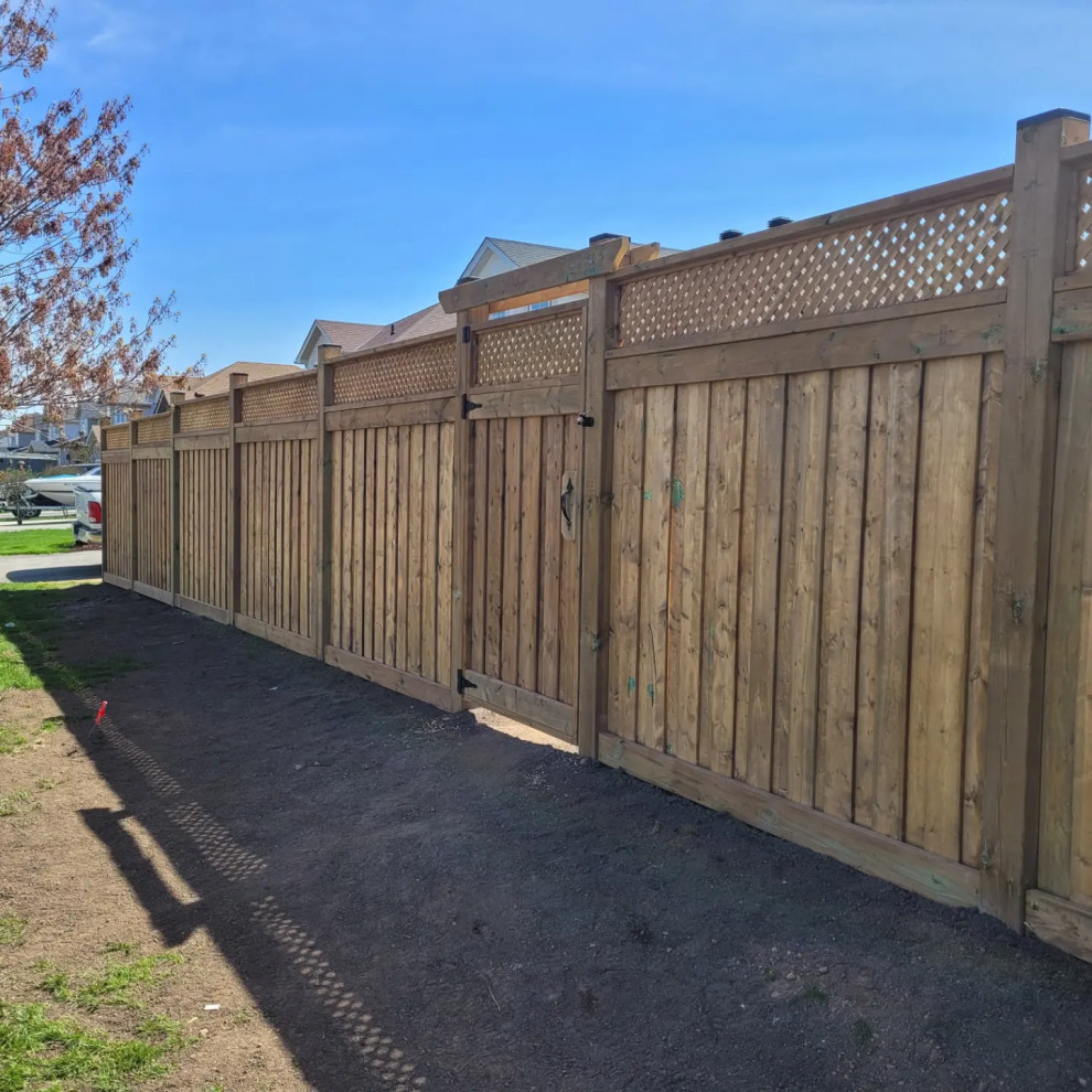 This is an example of a mid-sized backyard garden in Toronto with with privacy feature and a wood fence.