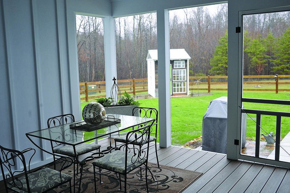 Photo of a mid-sized country backyard screened-in verandah in DC Metro with decking.