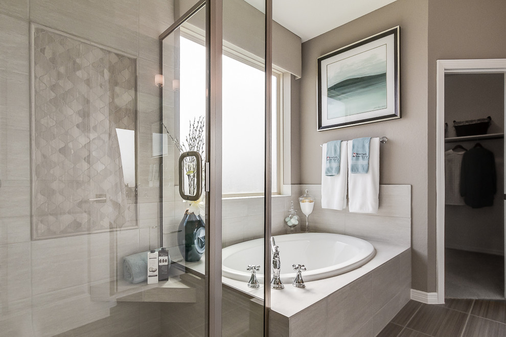 This is an example of a modern master bathroom in Houston with shaker cabinets, gray tile, ceramic tile, grey walls, a corner tub, ceramic floors, grey floor and a hinged shower door.