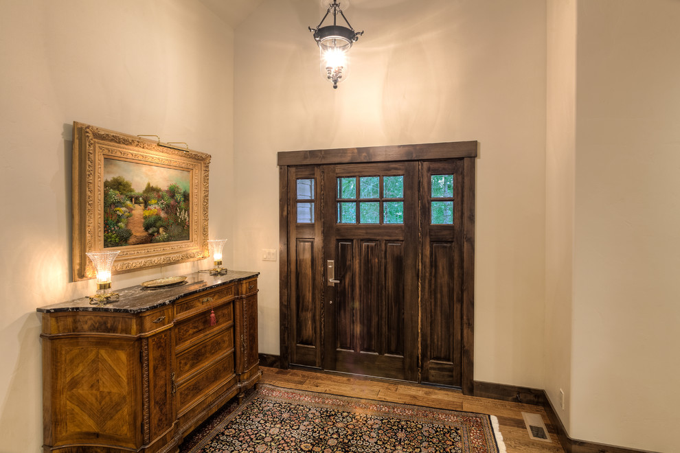 Single front door - light wood floor single front door idea with beige walls and a dark wood front door
