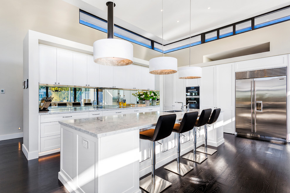 Contemporary galley kitchen in Sydney with a double-bowl sink, shaker cabinets, white cabinets, stainless steel appliances, dark hardwood floors and with island.