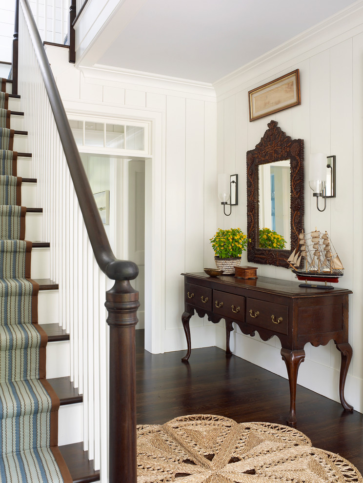 Large elegant wooden u-shaped staircase photo in Jacksonville with painted risers