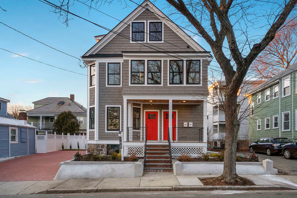Traditional three-storey grey duplex exterior in Boston with wood siding and a gable roof.