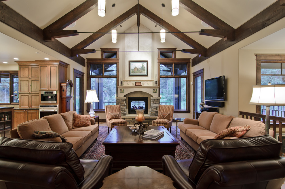 Photo of a traditional living room in Denver with a stone fireplace surround.