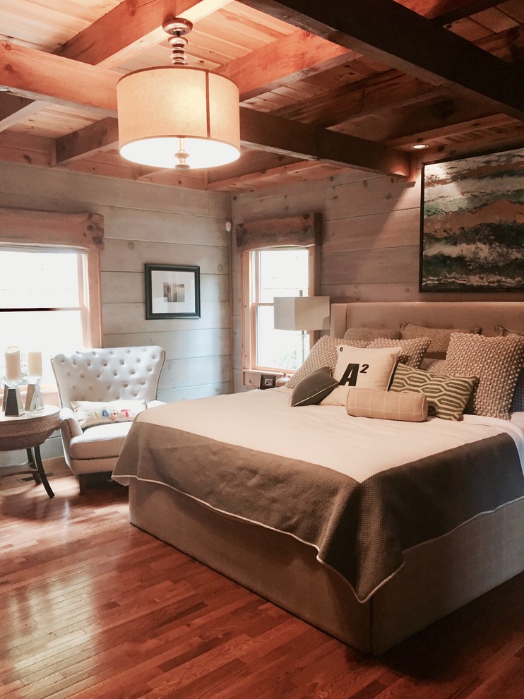 Photo of a mid-sized country master bedroom in Other with grey walls and medium hardwood floors.