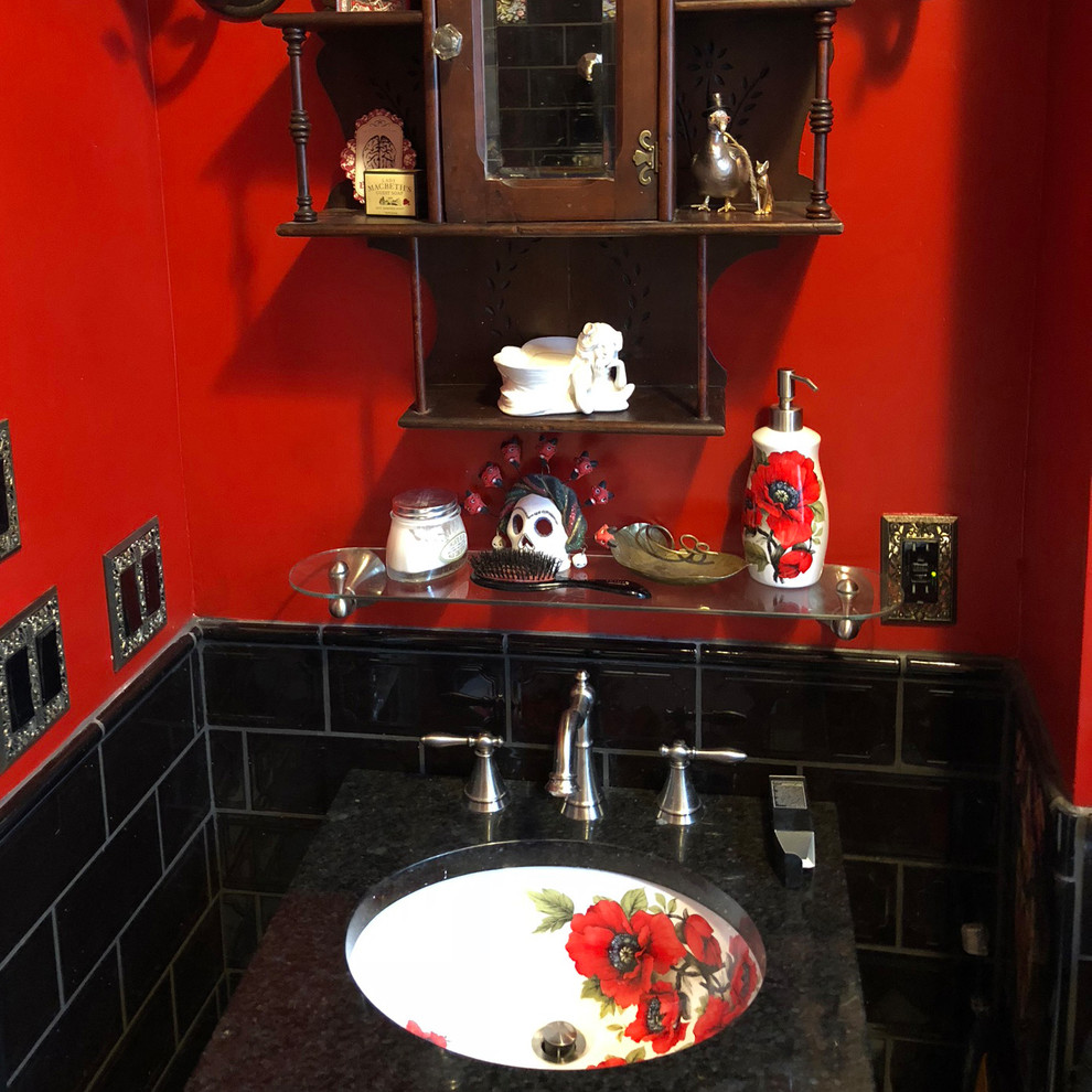 Design ideas for a small eclectic powder room in Austin with black tile, glass tile, red walls, an undermount sink, marble benchtops and black benchtops.
