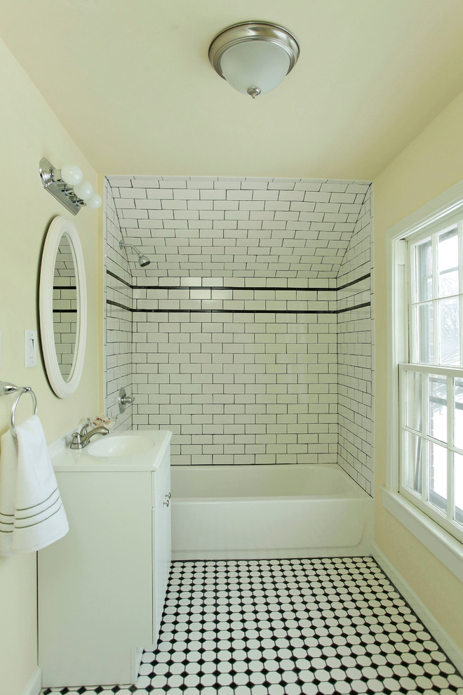 Photo of a small contemporary master bathroom in Other with an integrated sink, flat-panel cabinets, dark wood cabinets, solid surface benchtops, a drop-in tub, a shower/bathtub combo, a two-piece toilet, white tile, subway tile, yellow walls and mosaic tile floors.