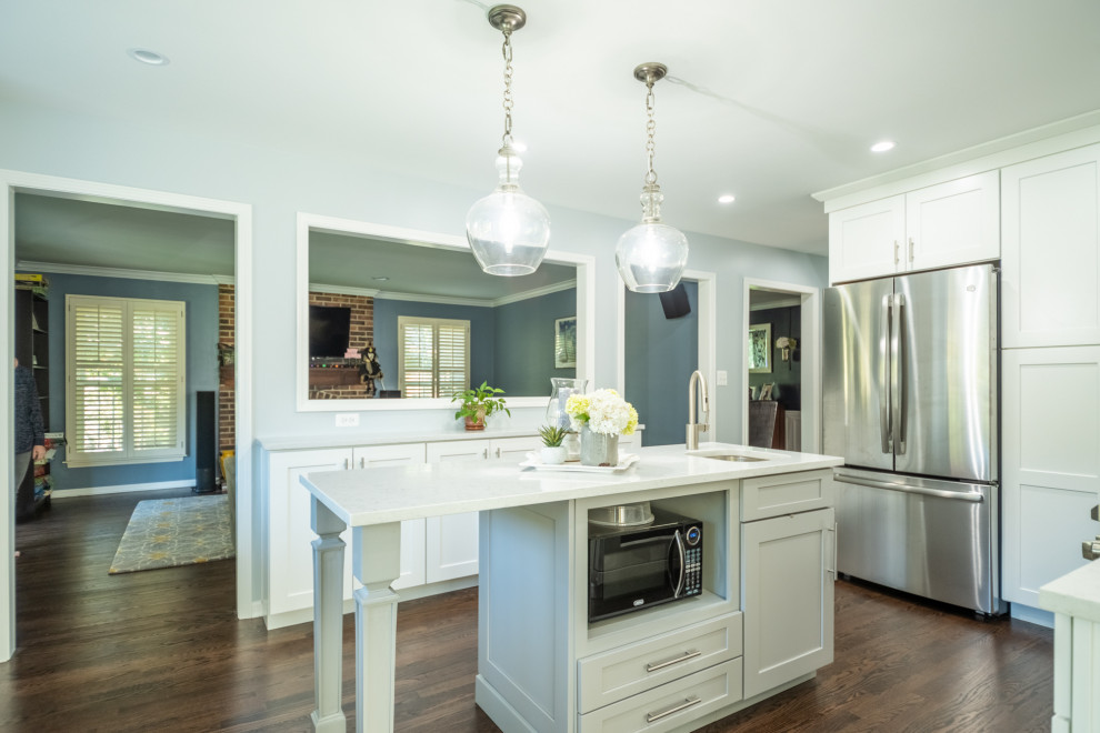 Mid-sized transitional dark wood floor and brown floor kitchen photo in Chicago with an undermount sink, shaker cabinets, white cabinets, quartz countertops, gray backsplash, mosaic tile backsplash, stainless steel appliances, an island and white countertops