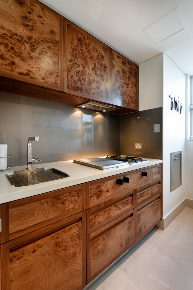 Inspiration for a huge contemporary galley travertine floor and beige floor eat-in kitchen remodel in Perth with a double-bowl sink, flat-panel cabinets, medium tone wood cabinets, quartz countertops, metallic backsplash, glass tile backsplash, black appliances, an island and white countertops