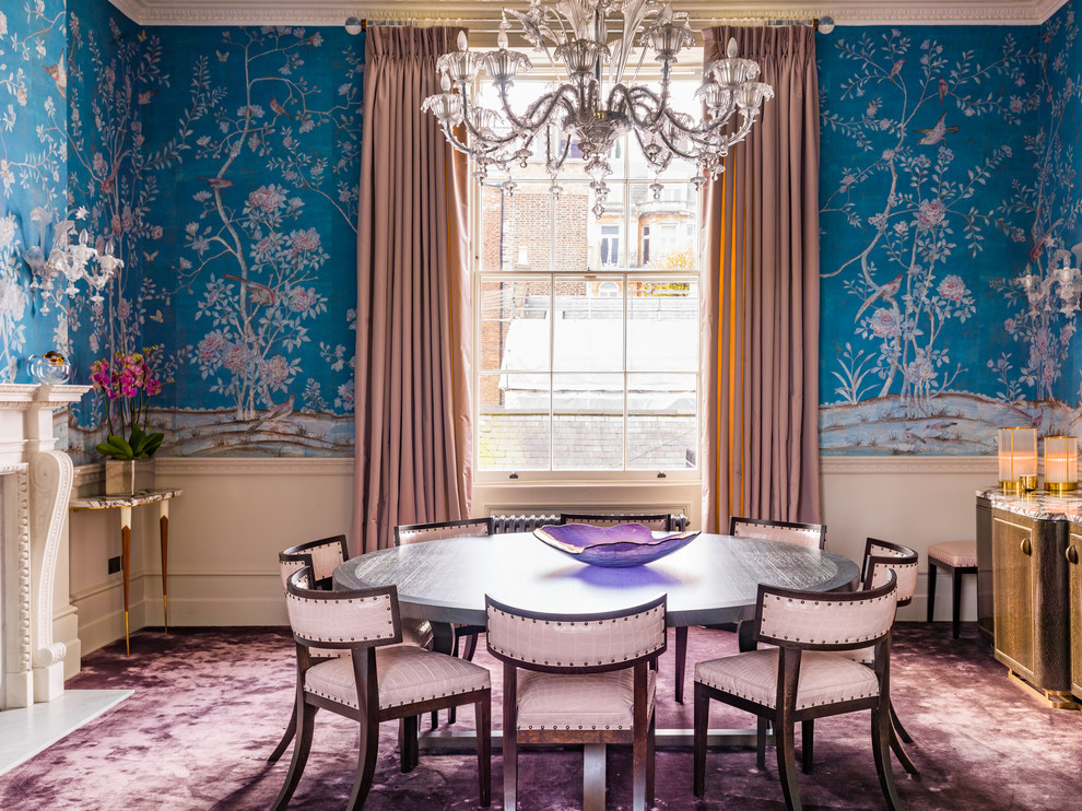 This is an example of a large traditional open plan dining in London with blue walls, carpet, a standard fireplace, a stone fireplace surround and purple floor.