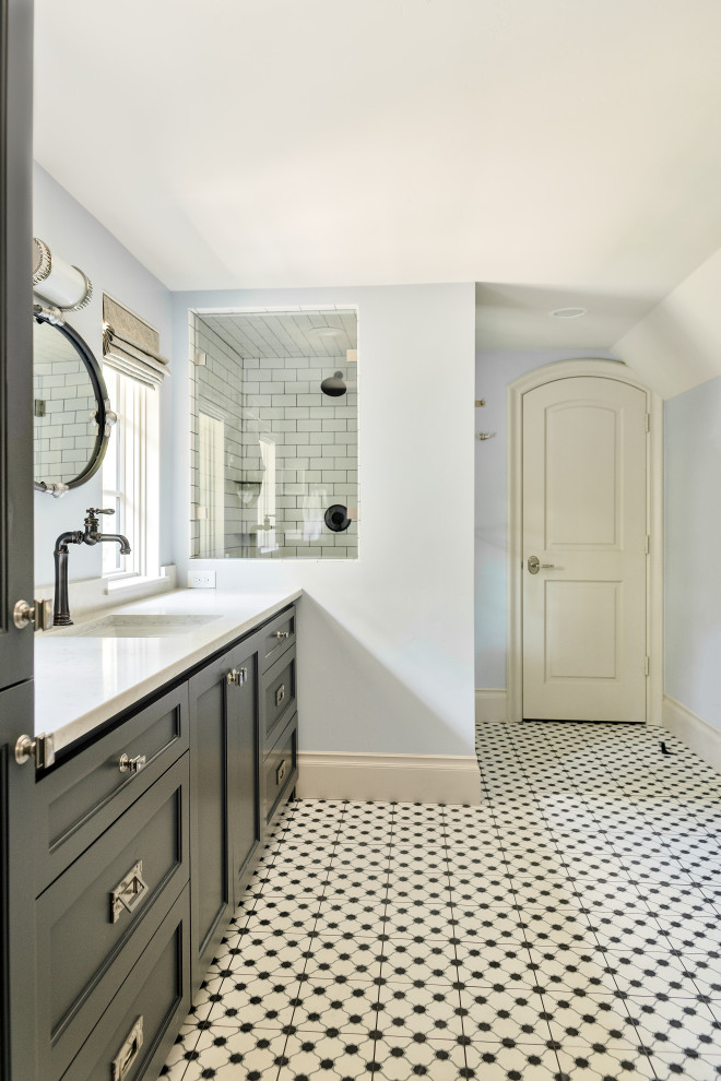 This is an example of a mid-sized traditional kids bathroom in Dallas with shaker cabinets, grey cabinets, blue walls, cement tiles, marble benchtops, multi-coloured floor, white benchtops, a single vanity and a built-in vanity.