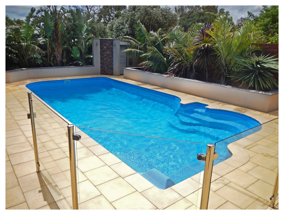 Inspiration for a mid-sized contemporary backyard custom-shaped natural pool in Perth with a water feature and natural stone pavers.